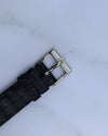 Original Piaget 18K white gold buckle with logo, attached to black leather strap