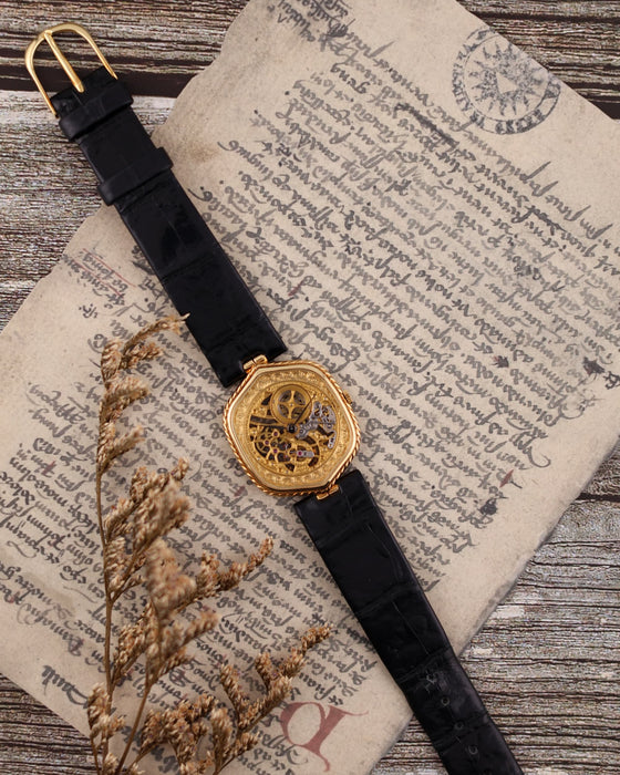 Audemars Piguet 1980s skeleton watch in 18K yellow gold with engraved skeleton dial and black leather strap