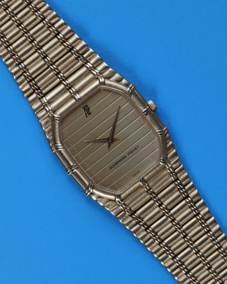 Ribbed gold-tone dial of Audemars Piguet Bamboo watch reflecting light in soft vertical wave