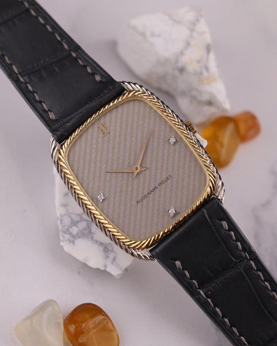 Close-up of silver dial with diagonal texture and diamond markers at 3, 6, and 9 o’clock on Audemars Piguet dress watch