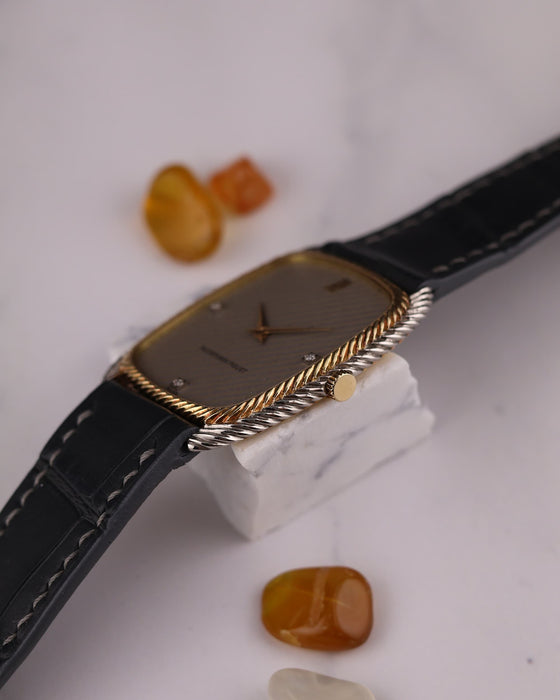 Crown-side view of Audemars Piguet 1970s dress watch highlighting yellow gold crown and case detailing