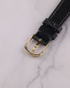 Underside of Audemars Piguet braided gold buckle attached to vintage leather strap
