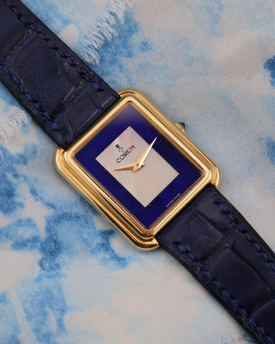 Front view of Corum 18K yellow gold tank watch with mother-of-pearl and lapis lazuli dial