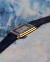 Side profile of the Corum stepped bezel case in 18K gold, displaying sleek mid-century design