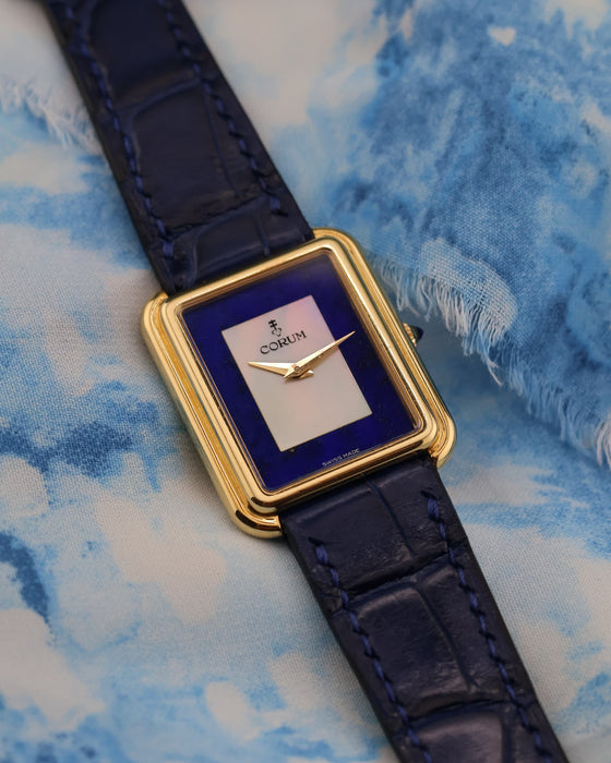 Vintage Corum gold tank watch on leather strap, highlighting elegant Art Deco proportions