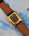 Case back of Corum 18K yellow gold tank watch, showing unpolished surface and clean finishing