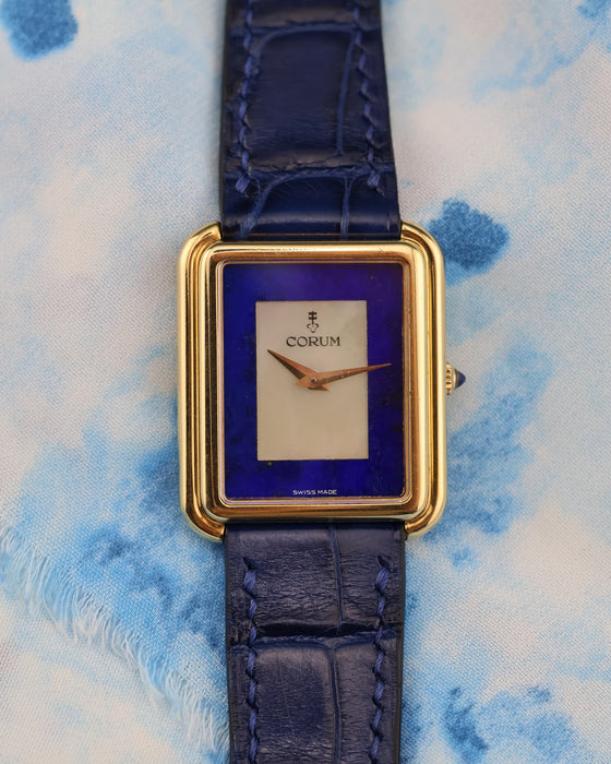 Close-up of Corum stepped bezel tank dial showcasing the luminous mother-of-pearl center and deep blue lapis lazuli surround