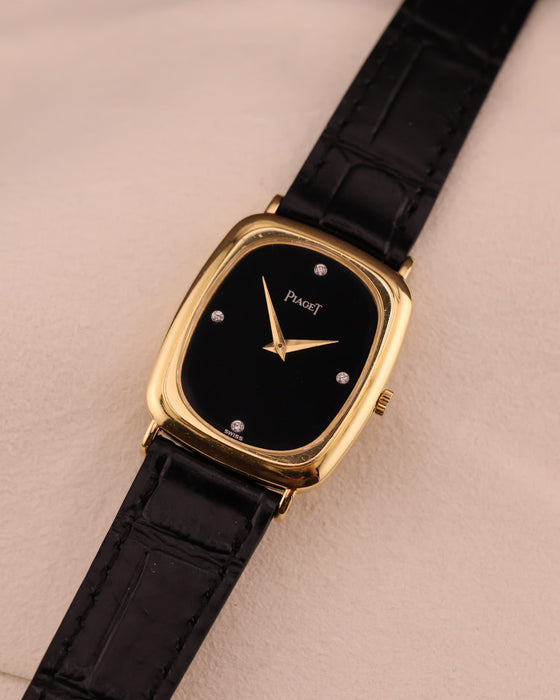 Alternate front angle of Piaget watch showcasing the sleek onyx dial and polished gold case.