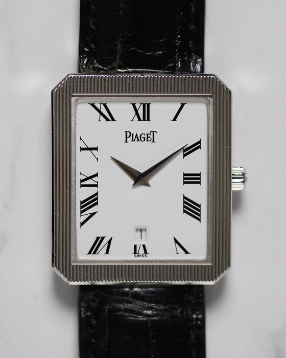 Close-up of Piaget Ref. 26354 dial featuring white background, black Roman numerals, and date window at 6 o’clock.