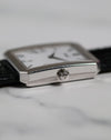 Detailed shot of Piaget Ref. 26354 signed crown with vertical fluted case edges in 18K white gold.