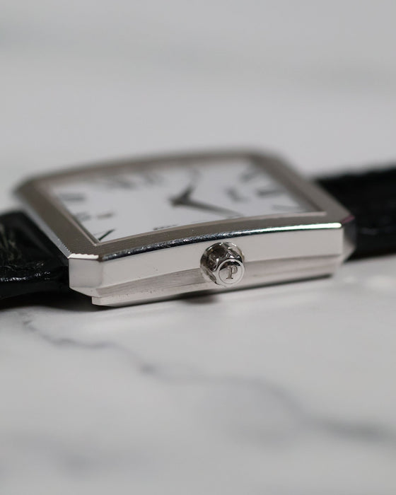 Detailed shot of Piaget Ref. 26354 signed crown with vertical fluted case edges in 18K white gold.