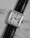 Frontal view of Piaget Ref. 26354 in 18K white gold with fluted bezel and Roman numeral dial on black leather strap.