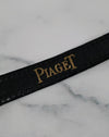 Close-up of the original Piaget black alligator strap with textured finish and taper toward the buckle.