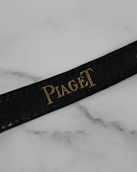 Close-up of the original Piaget black alligator strap with textured finish and taper toward the buckle.