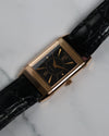 Angled shot of the Jaeger-LeCoultre Reverso highlighting the black dial and rose gold case.
