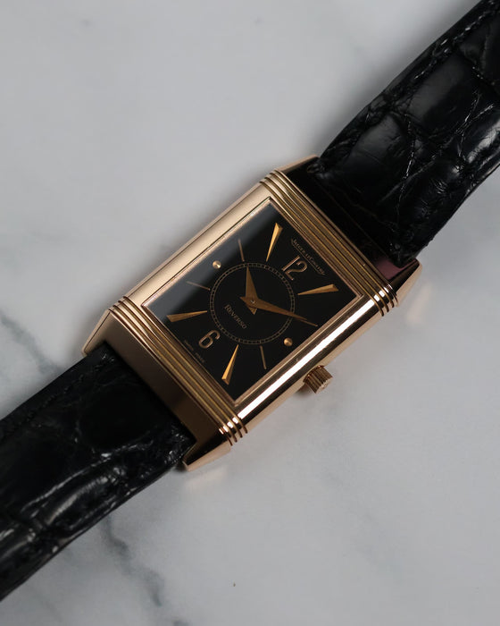 Angled shot of the Jaeger-LeCoultre Reverso highlighting the black dial and rose gold case.
