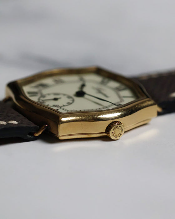 Close-up of the watch crown and case edge, highlighting the gold-plated finish and crisp transitions.