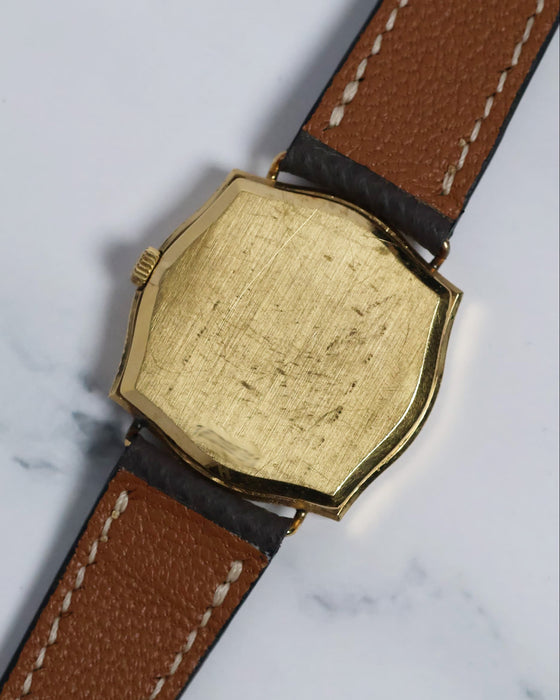 Rear view of the gold-plated caseback with vintage patina, showcasing the watch’s clean and classic design.