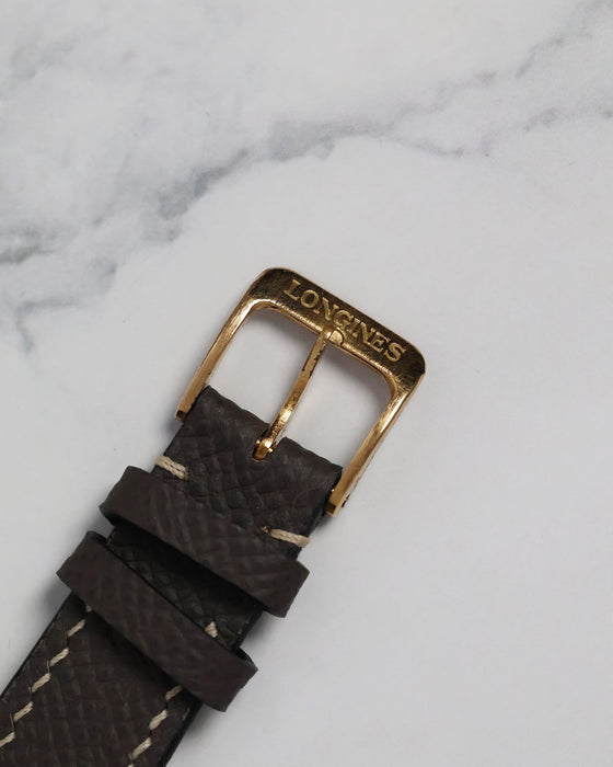Close-up of the original vintage buckle that accompanies the watch, preserving its period-correct charm.