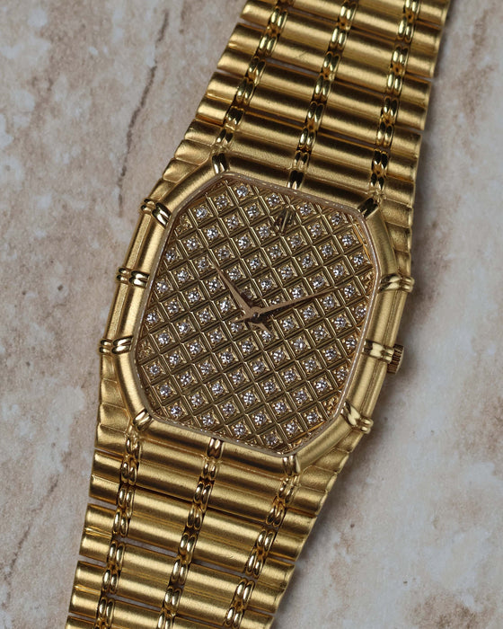 Close-up of Audemars Piguet Bamboo 27mm showcasing the full pavé diamond dial and bamboo-style gold case.