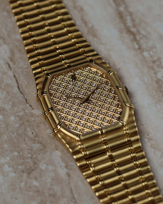 Elegant wristwatch view of the Audemars Piguet Bamboo 27mm in 18K yellow gold with diamond-set dial.