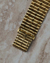 Top view of the integrated bamboo-style clasp on the Audemars Piguet 18K yellow gold bracelet.