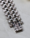 Close-up of the hidden clasp mechanism seamlessly integrated into the engraved white gold bracelet.