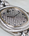 Macro of the diamond pavé dial with deep blue sapphire indexes capturing the light.