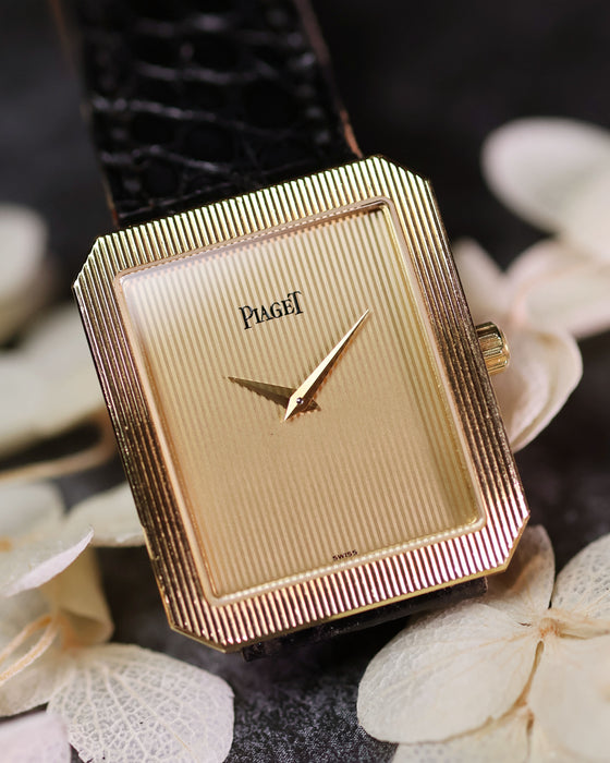 Piaget Protocole 90154 in 18K yellow gold with vertical tapestry dial on black leather strap.
