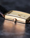 Close-up of 18K yellow gold crown on Piaget Protocole 90154, highlighting case fluting detail.