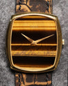 Close-up of the horizontal Tiger’s Eye dial with golden dauphine hands on the Piaget 9741