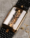 Angled front shot of the Corum Golden Bridge 13150, emphasizing the depth of the transparent case and the vertical alignment of the linear skeleton movement with engraved bridge.