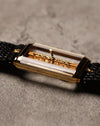 Angled wrist-side view of the Corum Golden Bridge 13150, emphasizing the floating movement inside the sapphire case and the polished gold frame.