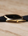 Close-up of the Piaget 9591’s small gold crown integrated into the slim cushion case profile.