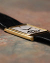 Side profile of Audemars Piguet Skeleton Aperture Tank showing slim 18K yellow gold case and curved sapphire crystal.