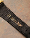Macro detail of Audemars Piguet leather strap with gold-stamped brand signature.