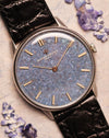 Close-up of the Vacheron Constantin Ref. 2006 showing the titanium blue mosaic dial, gold baton hands, and indices under soft natural light.