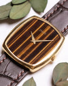 Angled shot of Piaget Ref. 9741 highlighting its vertical Tiger’s Eye stone dial and minimalist gold dauphine hands