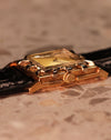 Side profile of the LeCoultre 14K gold Art Deco watch highlighting the stepped bezel design and manual-wind crown.