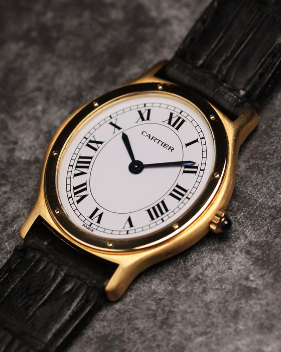 Angled front view of the Cartier Arcade LM Ref. 9605 highlighting its slim gold case and white dial.
