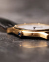 Macro side view of the Cartier Arcade LM Ref. 9605 showing the blue cabochon crown and case flank.