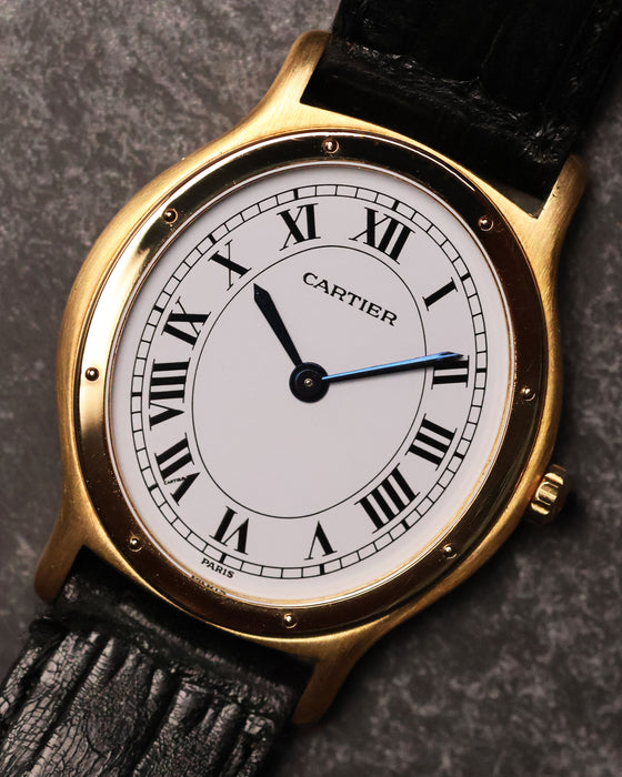 Close-up front view of the Cartier Arcade LM Ref. 9605 with its white dial, Roman numerals and gold bezel.