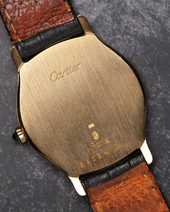 Caseback of the Cartier Arcade LM Ref. 9605 in 18k yellow gold showing Cartier engravings and brushed finish.