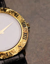 Macro detail of the Piaget 9118’s engraved gold bezel and crown, highlighting the carved Roman numerals and decorative scrollwork.