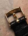 Back view of the Piaget tang buckle stamped “Piaget 18K 750,” mounted on a black leather strap.