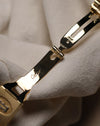 Interior view of the Cartier Santos Carrée folding clasp, displaying the polished gold components with Cartier engraving and hallmarks.