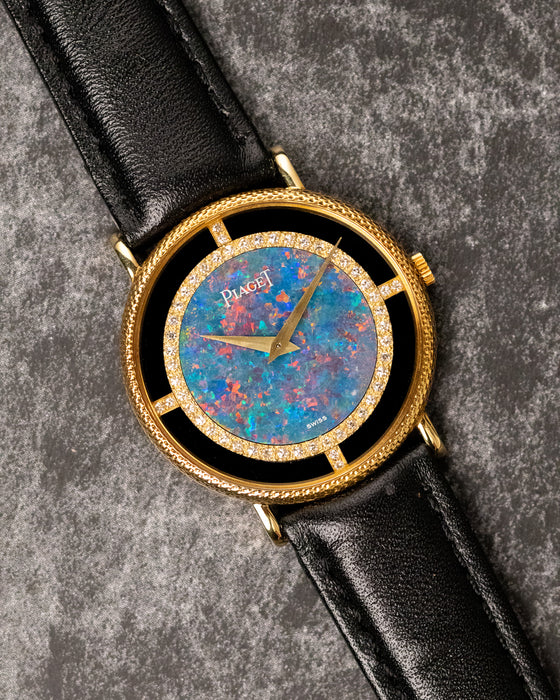 Piaget Ref. 9026 opal dial showing vivid blue, green, and fiery orange colour play with gold dauphine hands