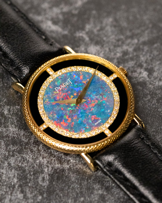 Angled close-up of Piaget Ref. 9026 highlighting textured 18K yellow gold case and opal dial