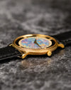 Side profile of Piaget Ref. 9026 showing engraved yellow gold case texture and slim manual-wind construction
