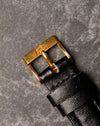 Original Piaget 18K yellow gold buckle fitted to black leather strap, top view